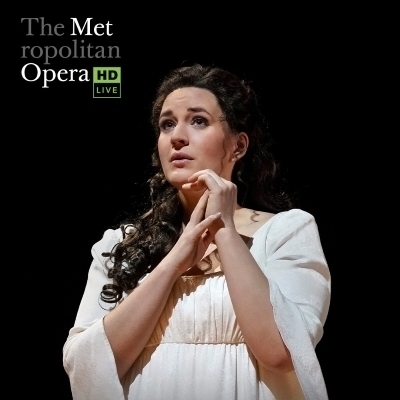 A woman holding her wrist looking ahead with "The Metropolitan Opera HD Live" logo