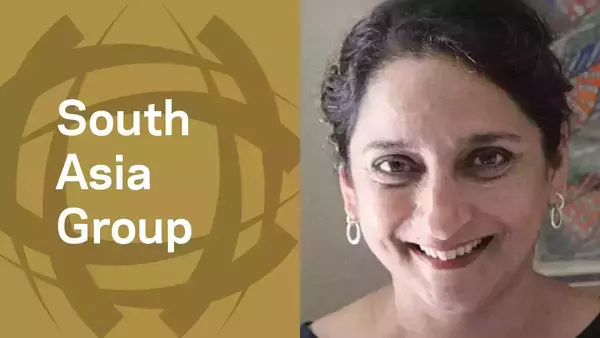 Meena Khandelwal, a smiling middle-aged woman with dark hair and hoop earrings.